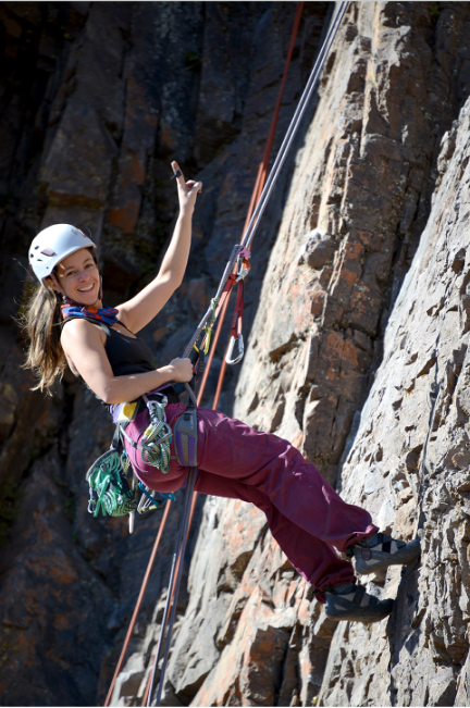 black hiking backpack near white Fujifilm instax mini camera near black leather boots, red half-zip jacket, gray pocket watch on white map