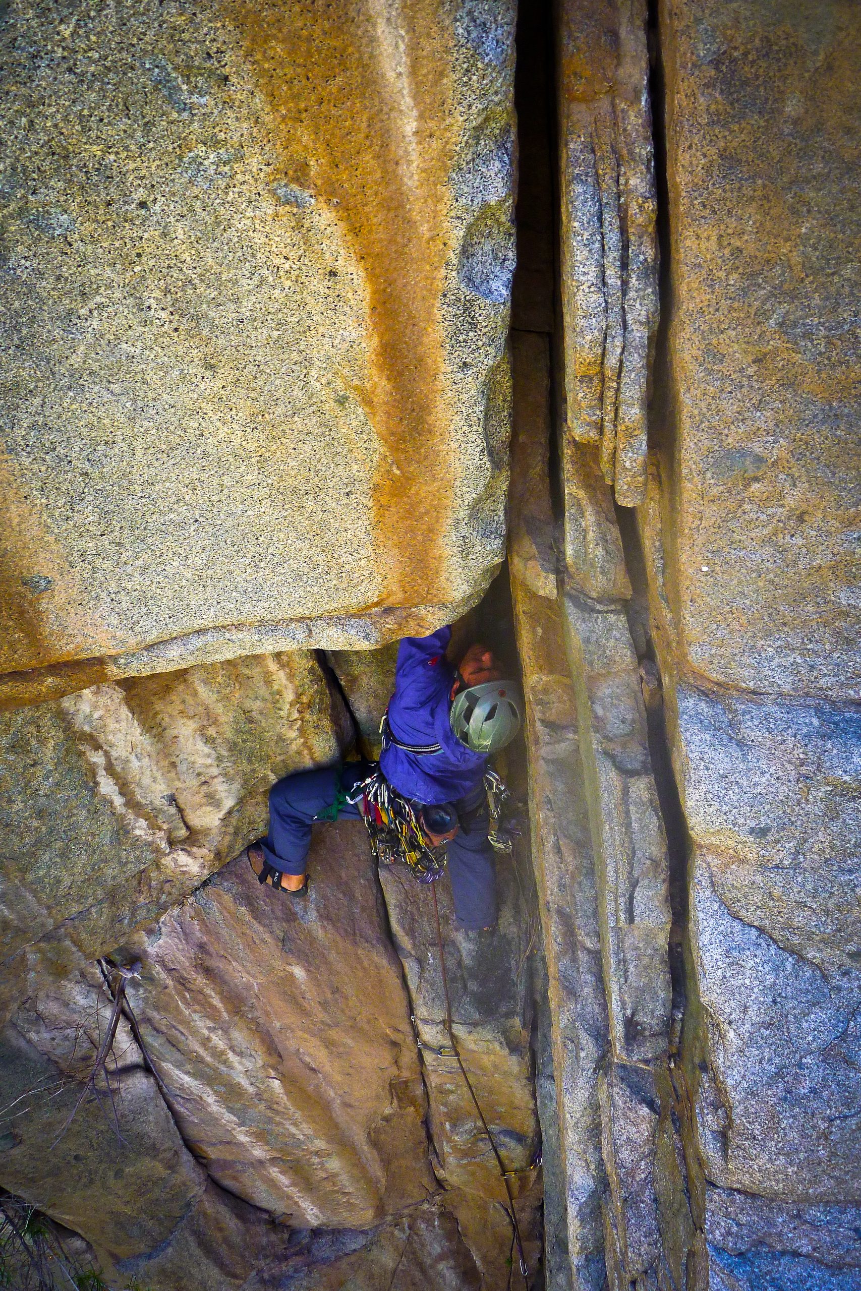 black hiking backpack near white Fujifilm instax mini camera near black leather boots, red half-zip jacket, gray pocket watch on white map